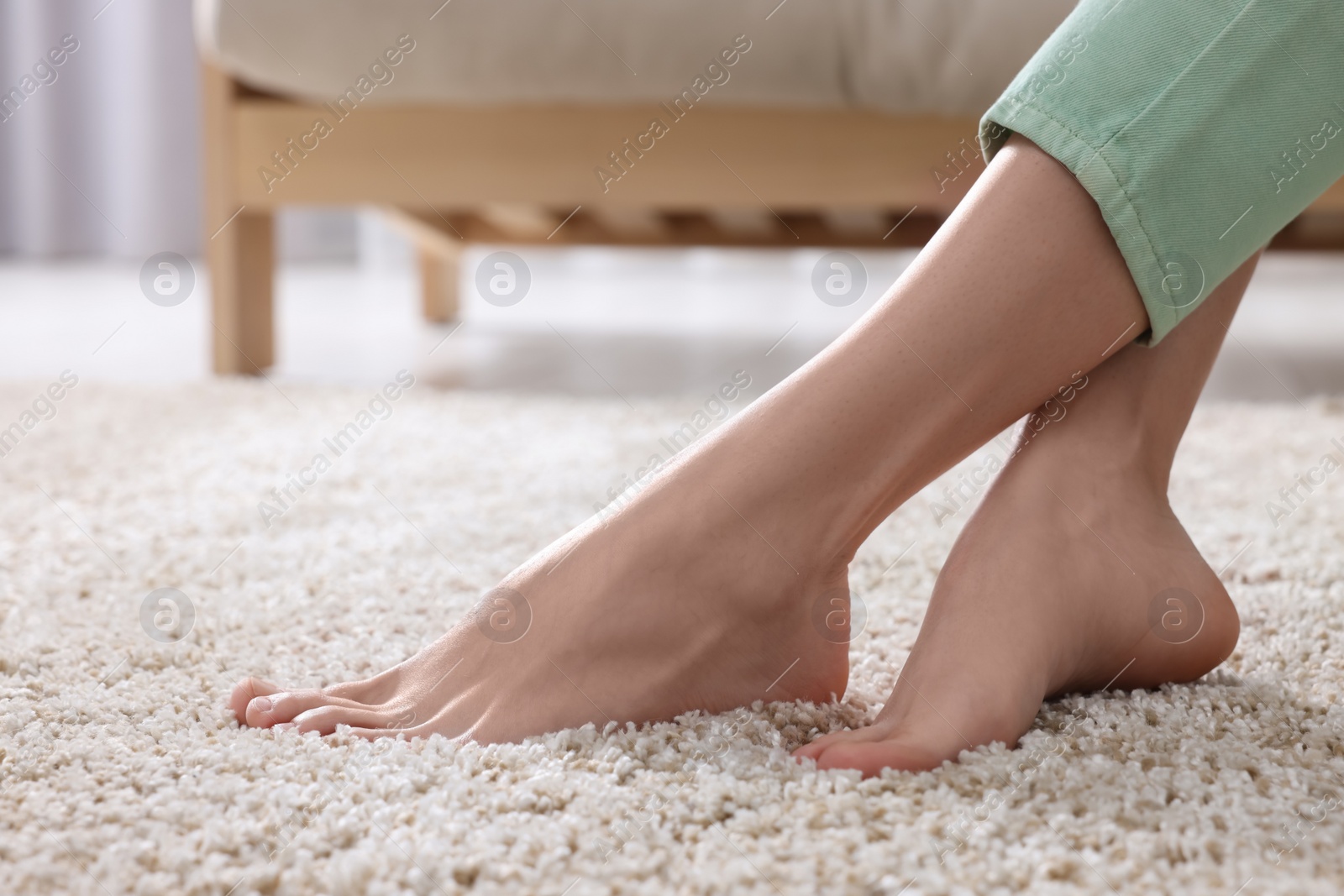 Photo of Woman on soft light brown carpet at home, closeup. Space for text