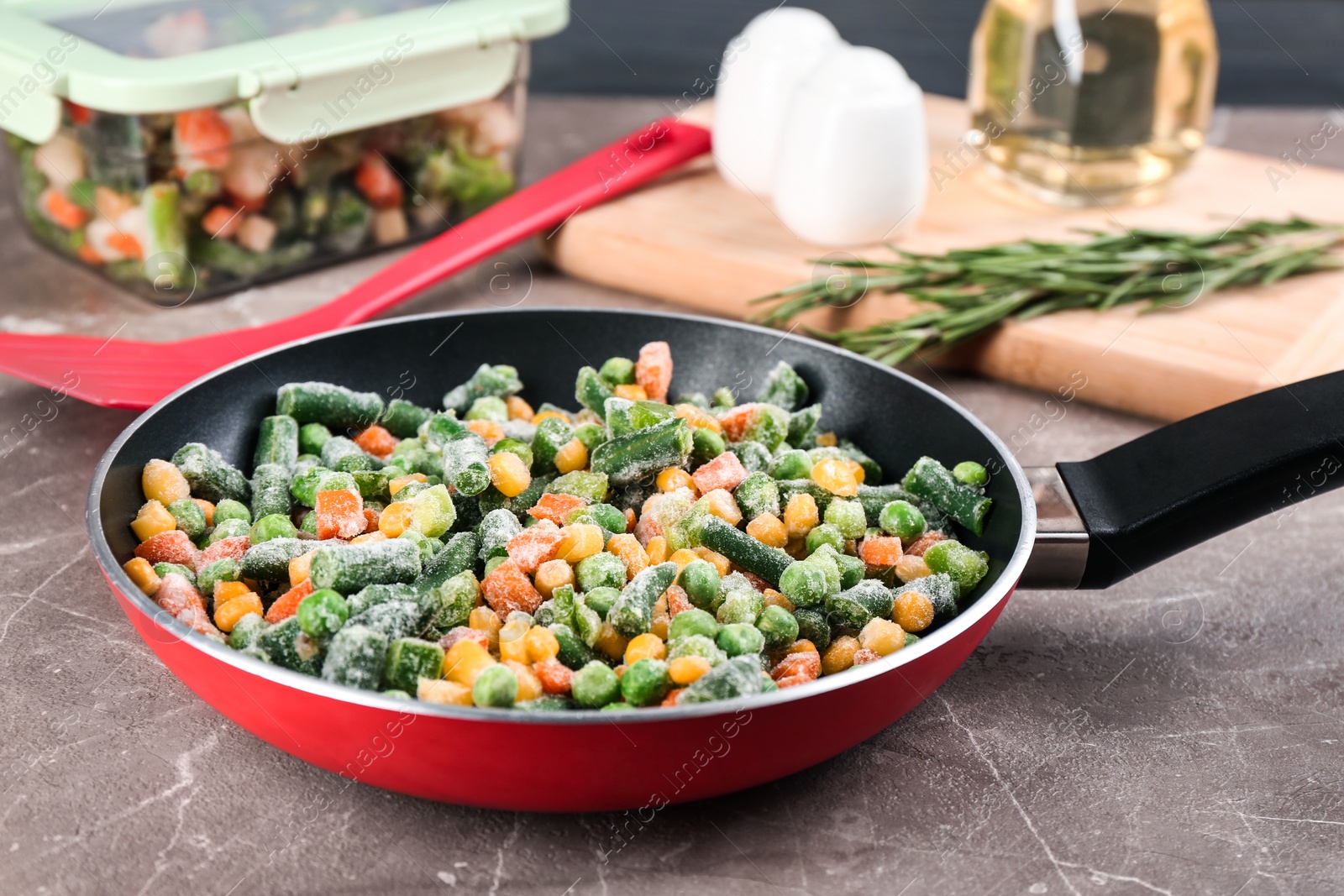 Photo of Tasty frozen vegetable mix on brown marble table