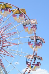 Photo of Large empty observation wheel against blue sky