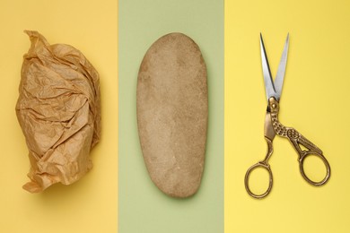 Photo of Rock, crumpled paper and scissors on color background, flat lay