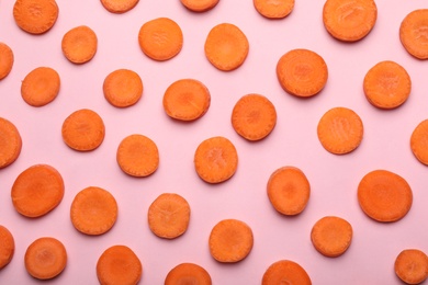 Flat lay composition with fresh carrot slices on color background