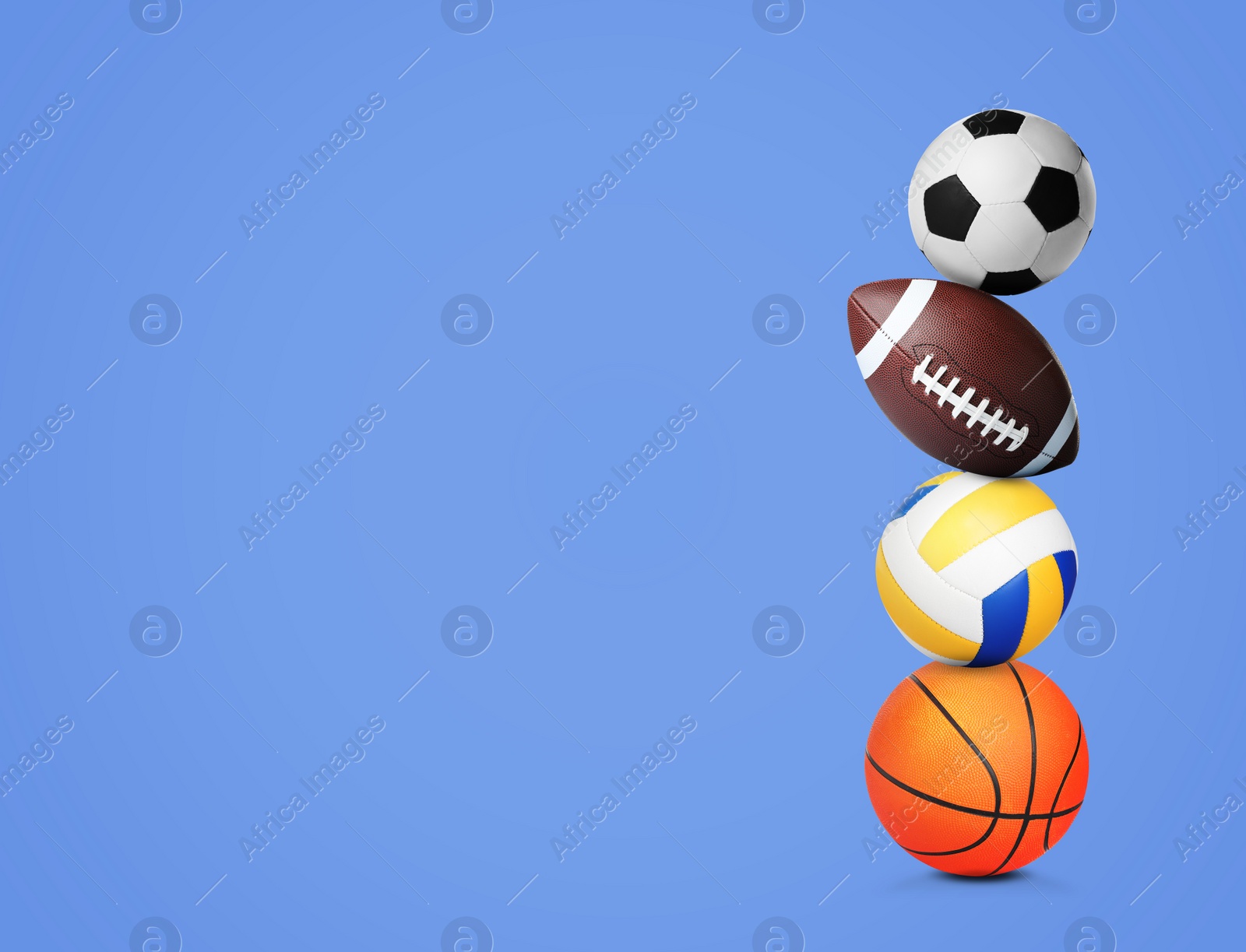 Image of Stack of different sport balls on blue background, space for text