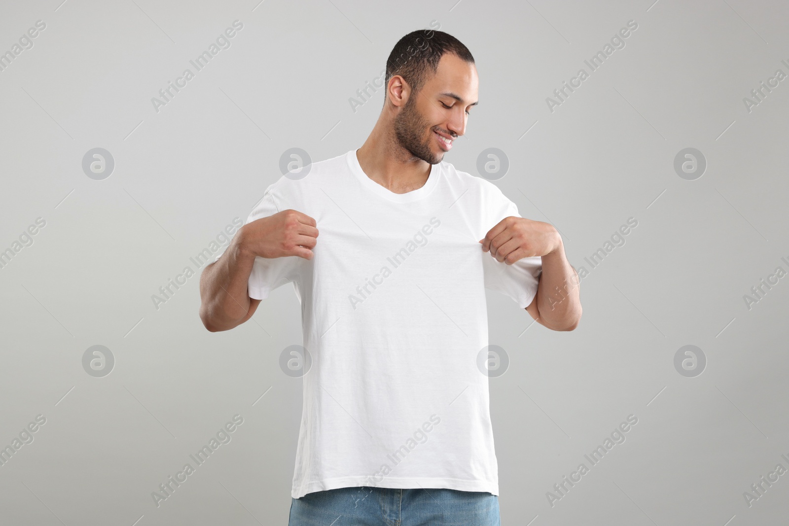 Photo of Man wearing white t-shirt on gray background