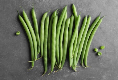 Photo of Fresh green beans on grey table, flat lay