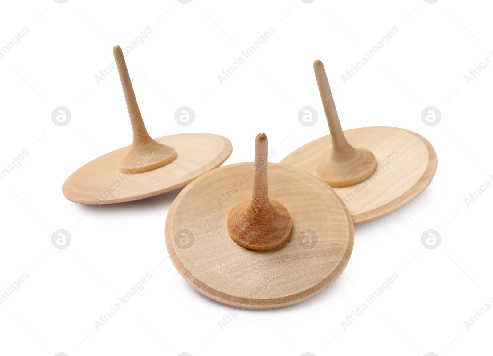 Photo of Many wooden spinning tops isolated on white