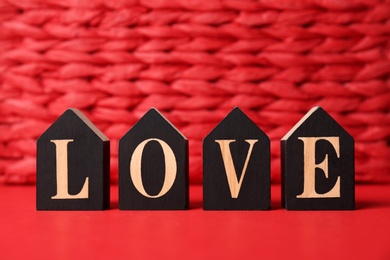 Word Love made with decorative letters on color background