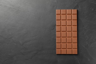 Tasty chocolate bar on grey table, top view. Space for text