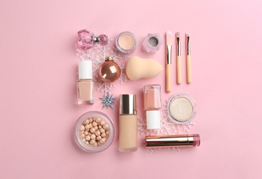 Photo of Flat lay composition with decorative cosmetic products on pink background. Winter care