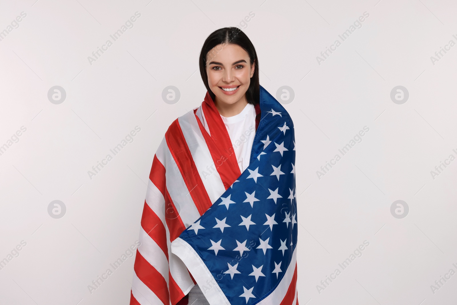 Photo of 4th of July - Independence Day of USA. Happy woman with American flag on white background