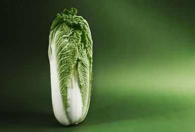 Photo of Fresh ripe Chinese cabbage on green background. Space for text