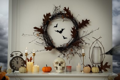 Photo of Different Halloween decor on mantelpiece indoors. Festive interior