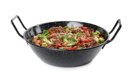 Photo of Stir-fry. Tasty noodles with meat and vegetables in wok isolated on white