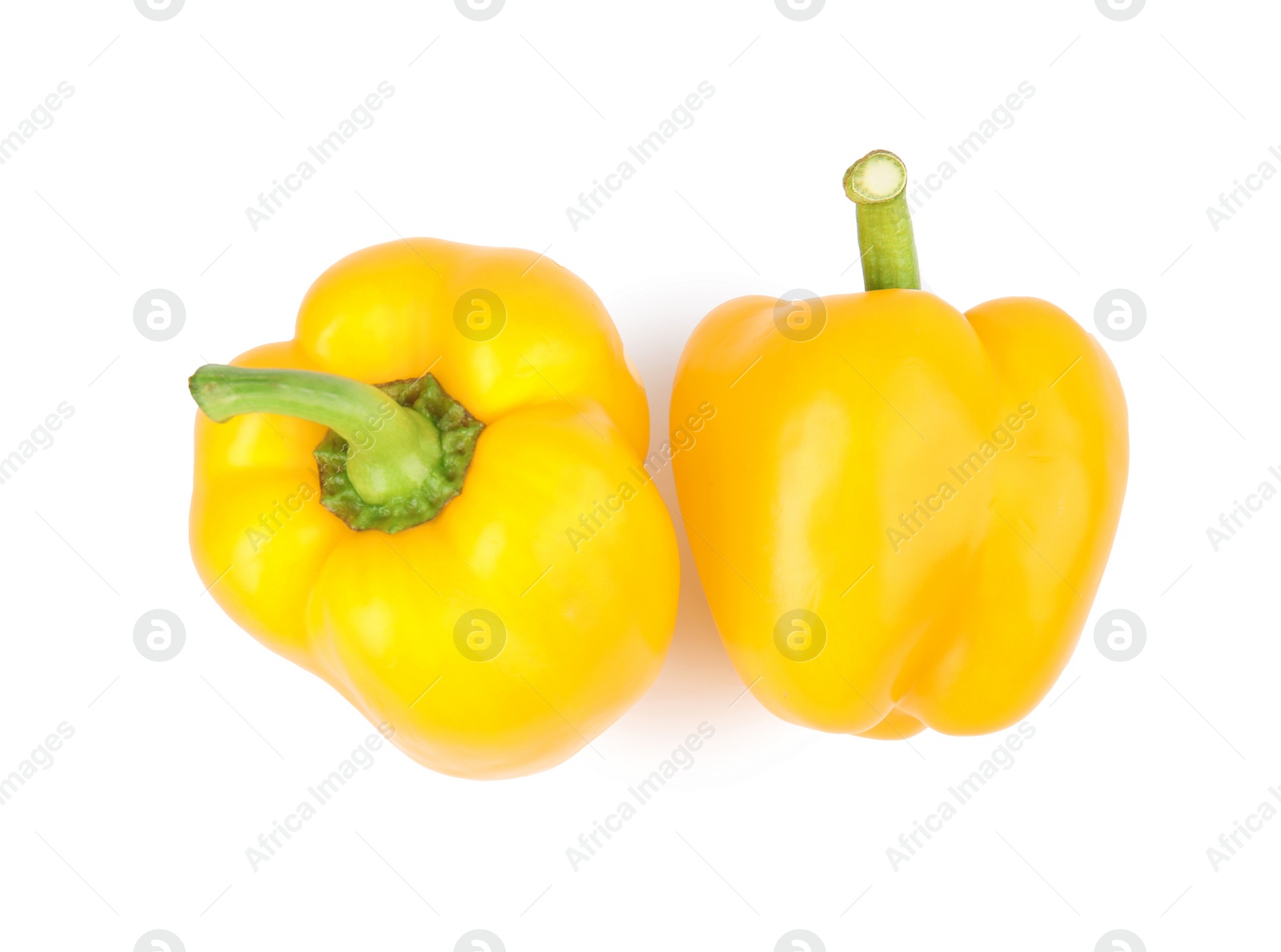 Photo of Ripe yellow bell peppers isolated on white, top view