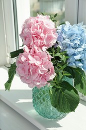 Photo of Bouquet with beautiful hortensia flowers on window sill
