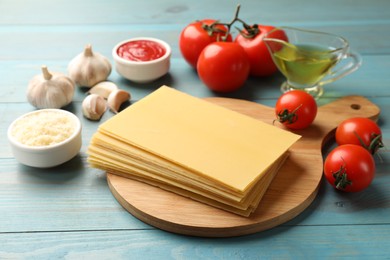 Photo of Ingredients for lasagna on blue wooden table
