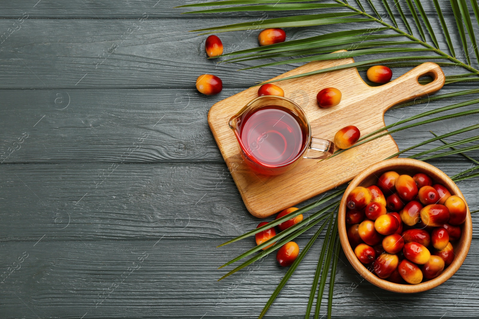 Image of Flat lay composition with palm oil and fresh fruits on grey wooden table. Space for text