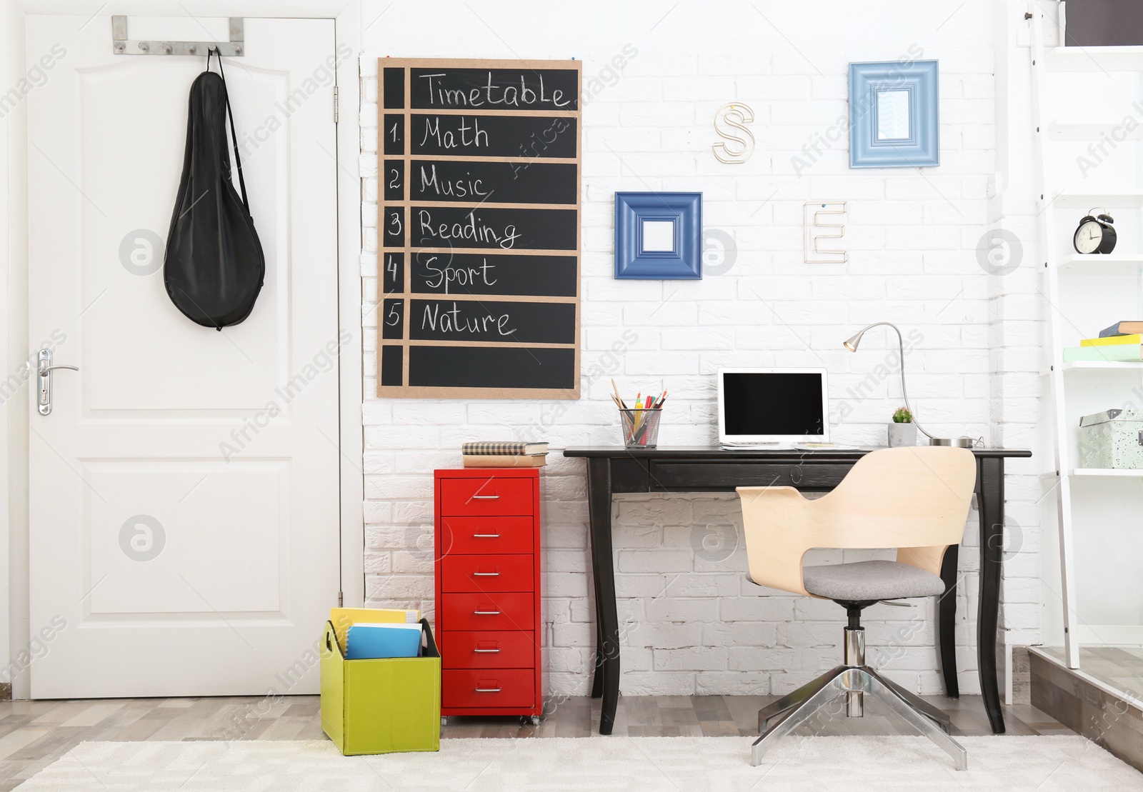 Photo of Modern child room interior with desk and laptop