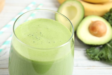 Photo of Tasty fresh kale smoothie on white wooden table, closeup