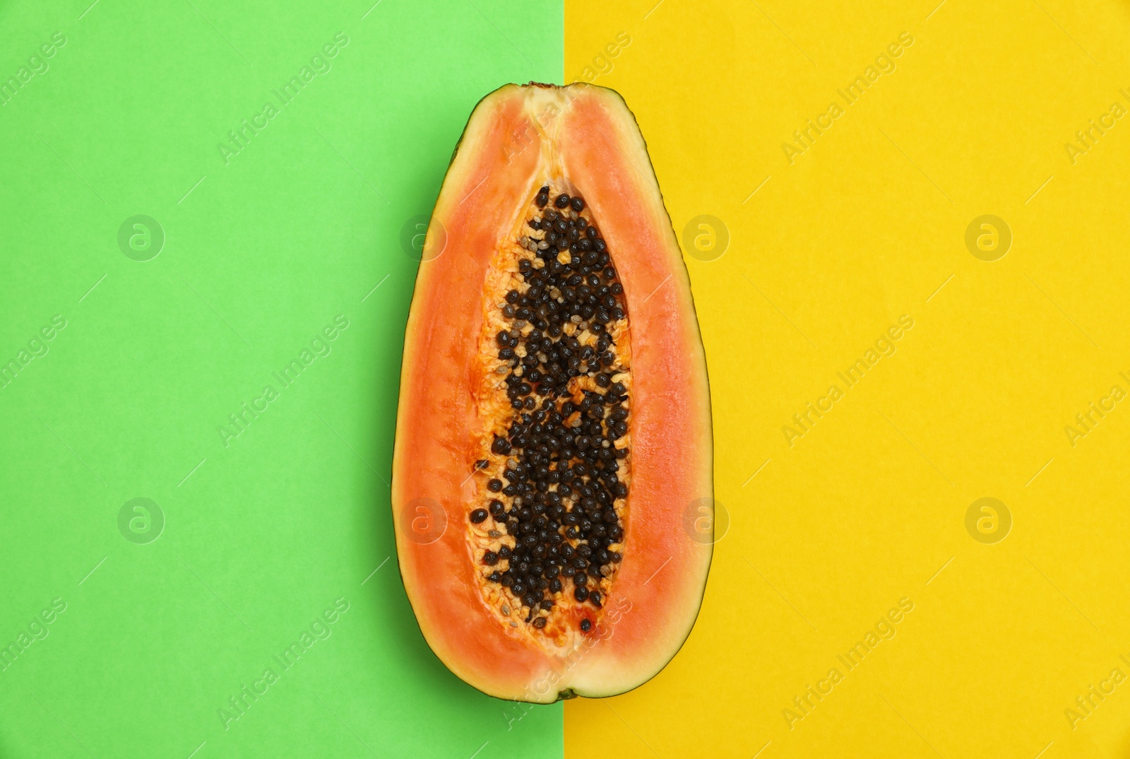 Photo of Fresh juicy halved papaya on color background, top view