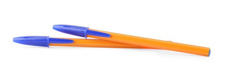 Photo of New orange plastic pens isolated on white