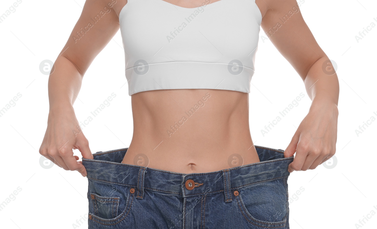 Photo of Slim woman wearing big jeans on white background, closeup. Weight loss