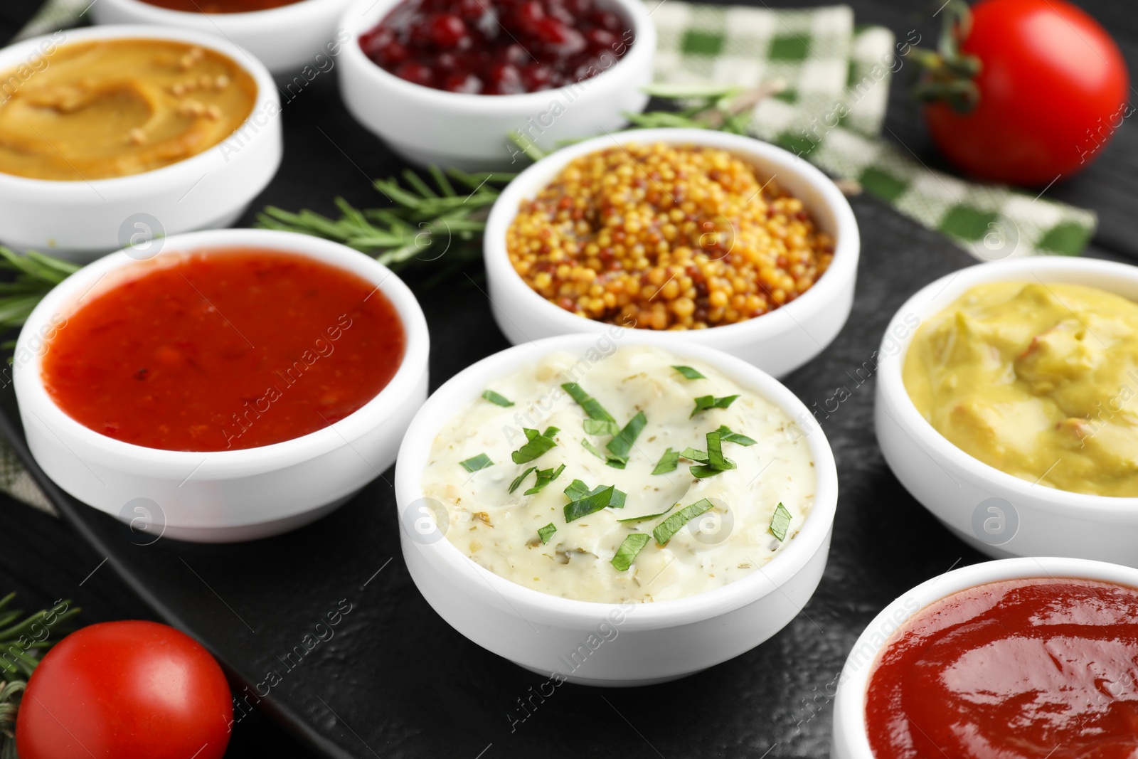 Photo of Different tasty sauces in bowls on table, closeup