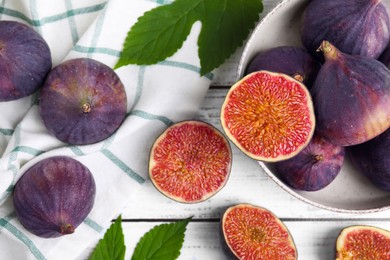 Photo of Fresh ripe figs on white wooden table, flat lay