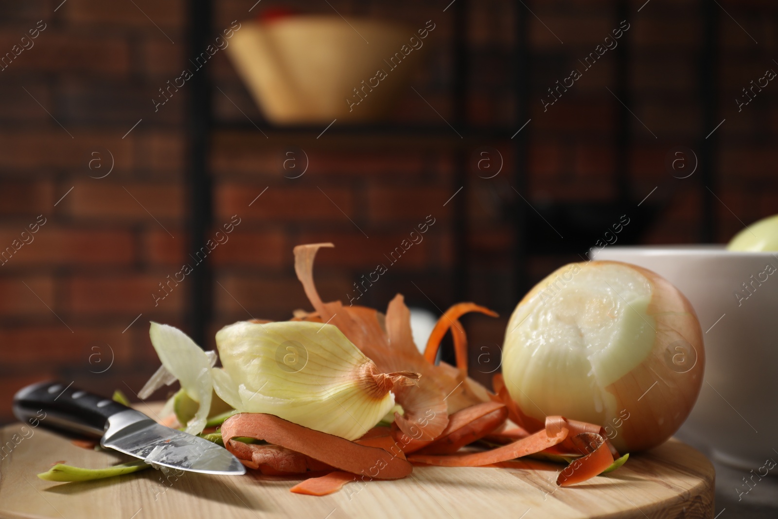 Photo of Peels of fresh vegetables and knife on table indoors