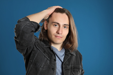 Portrait of young man on blue background