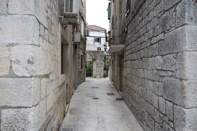 Photo of Picturesque view of passage between old buildings in city