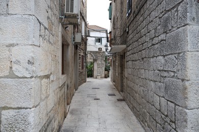 Picturesque view of passage between old buildings in city