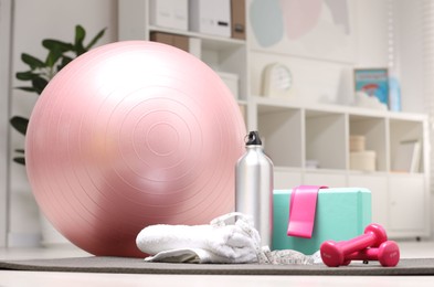 Photo of Many different sports equipment on floor indoors