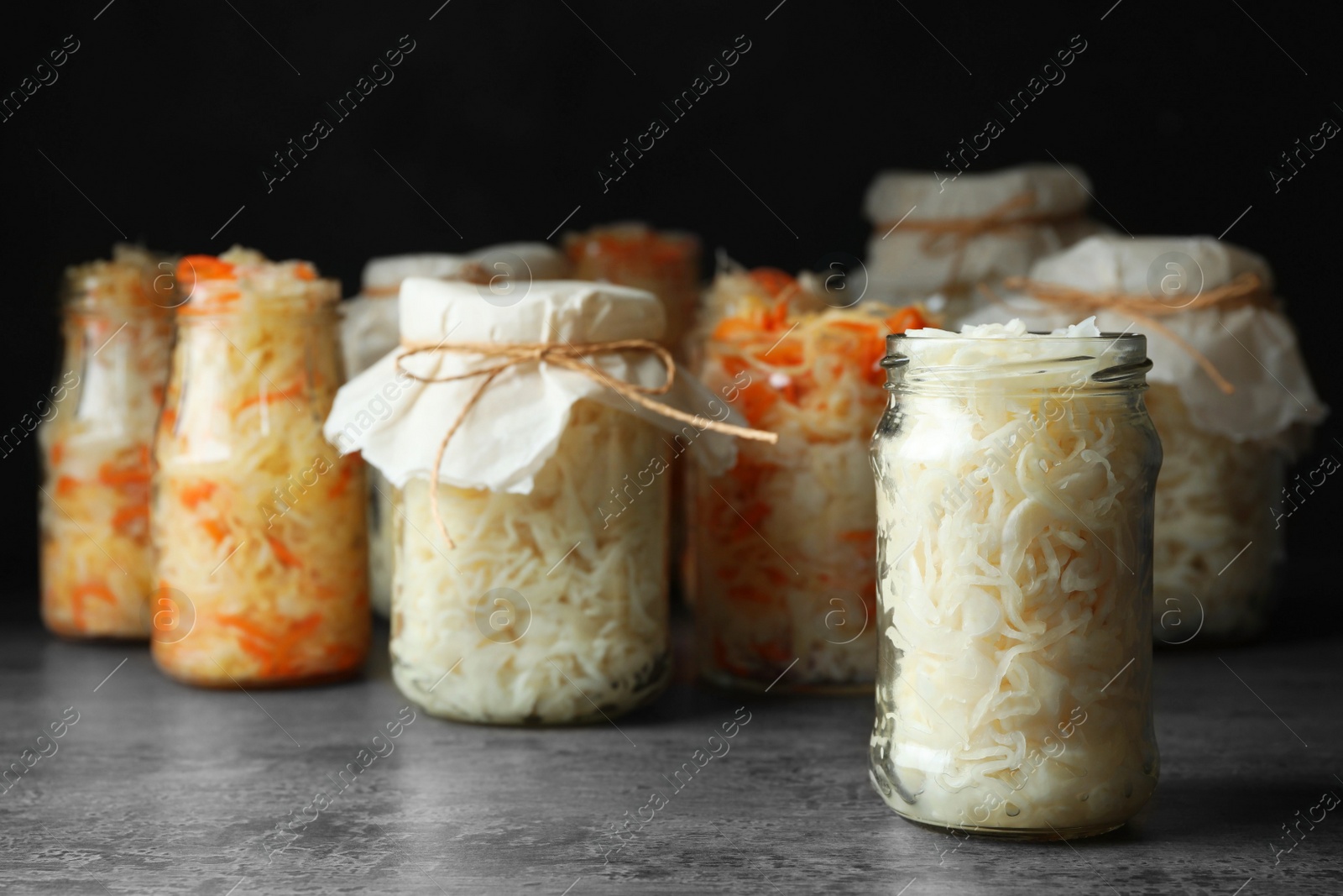 Photo of Tasty homemade fermented cabbage on grey table