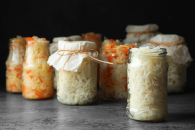 Tasty homemade fermented cabbage on grey table