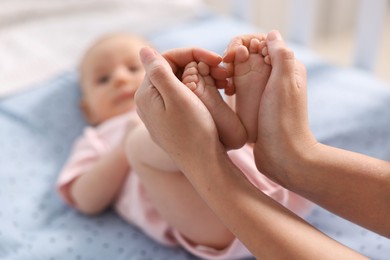 Photo of Mother with her cute little baby in crib, selective focus