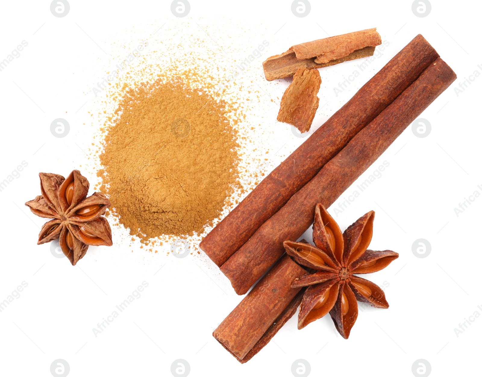 Photo of Dry aromatic cinnamon sticks, powder and anise stars isolated on white, top view