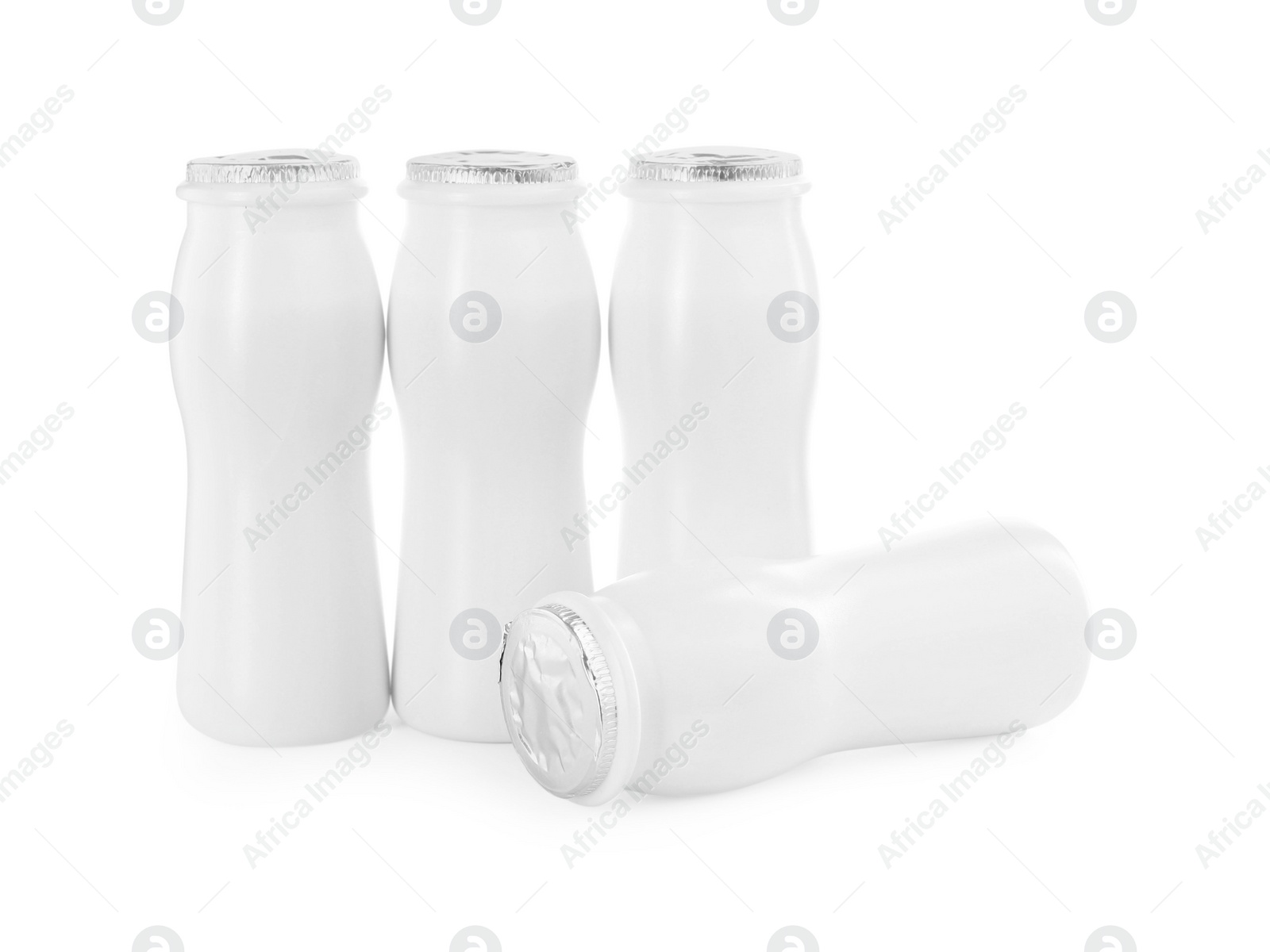 Photo of Tasty yogurt in bottles isolated on white