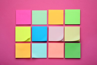 Photo of Colorful empty notes on pink background, flat lay