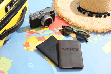 Passports and tourist items on world map. Travel agency