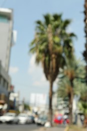 Photo of Blurred viewcity street with palm trees and buildings