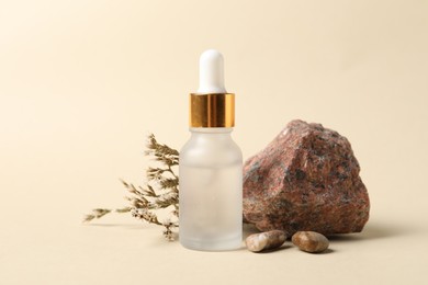 Photo of Composition with bottle of cosmetic serum on beige background