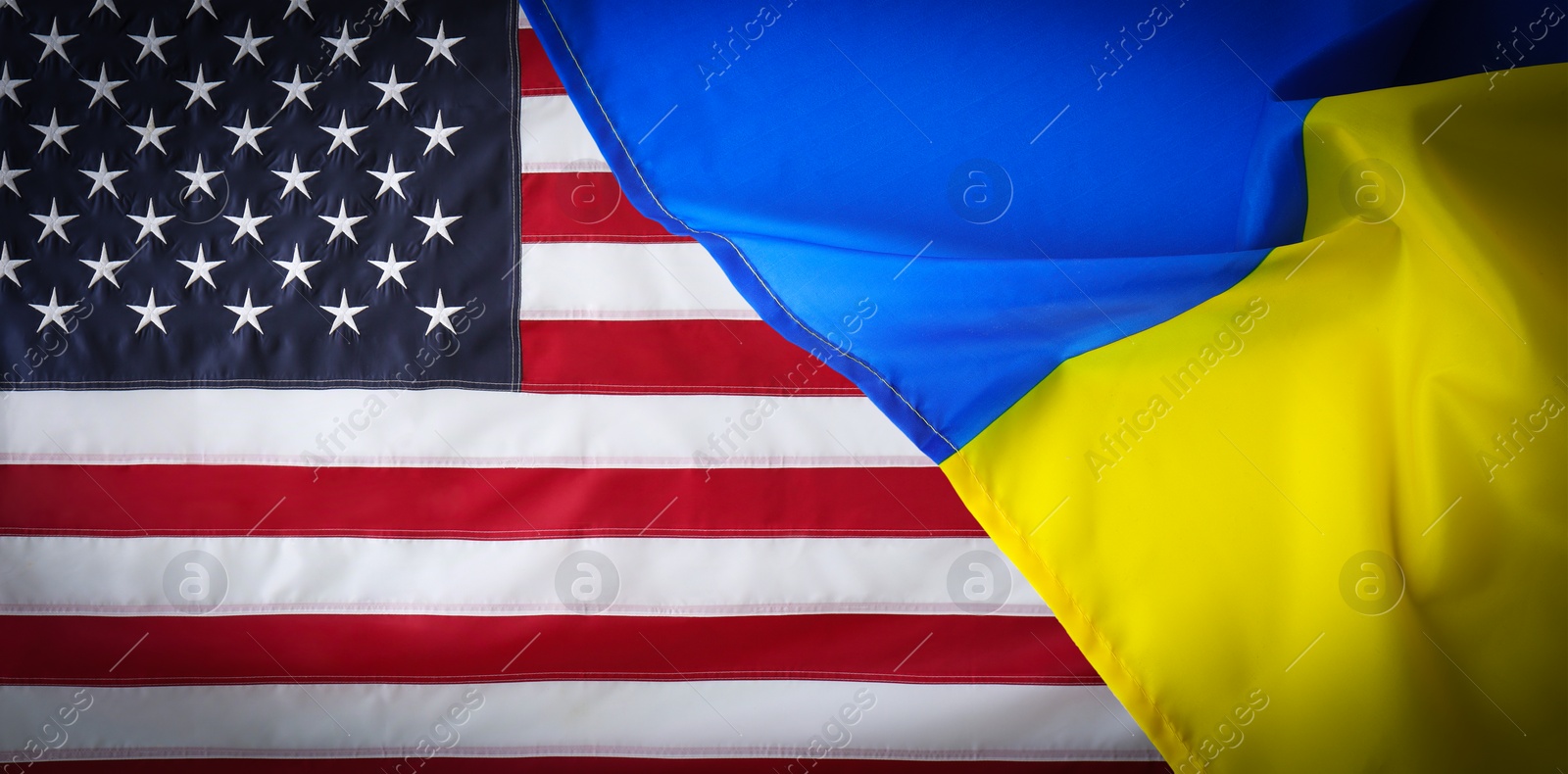 Image of National flags of Ukraine and USA symbolizing partnership between countries. Banner design