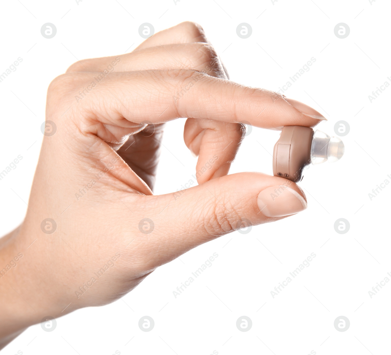 Photo of Woman holding hearing aid on white background, closeup