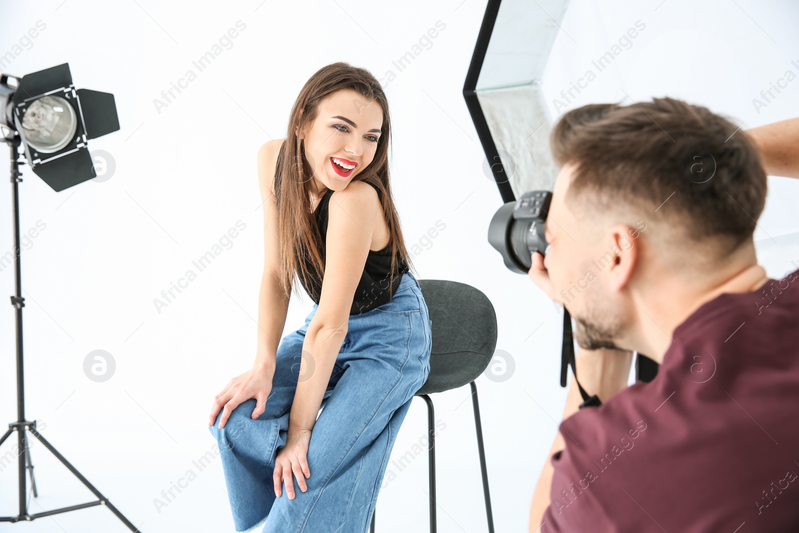 Photo of Beautiful young model posing for professional photographer in studio