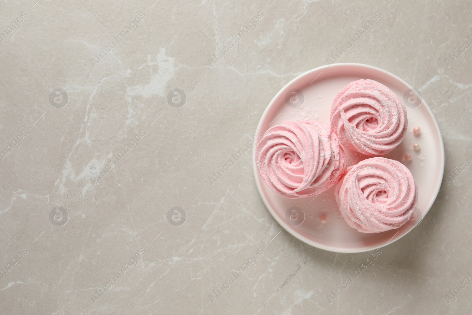 Photo of Delicious pink marshmallows on light grey table, top view. Space for text