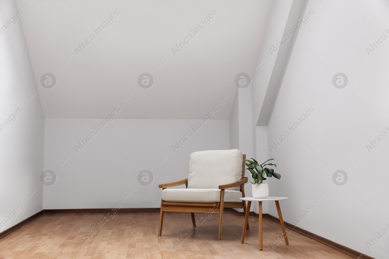 Photo of Attic spacious room interior with slanted ceiling and furniture