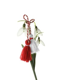 Photo of Beautiful snowdrops with traditional martisor on white background. Symbol of first spring day