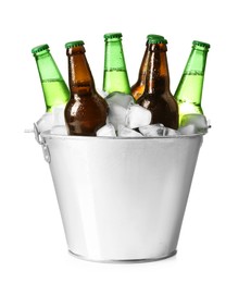 Metal bucket with different bottles of beer and ice cubes on white background