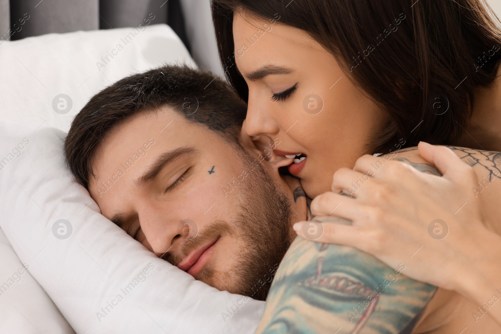 Photo of Passionate young couple having sex on bed