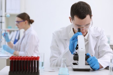 Photo of Scientist working with microscope in laboratory. Medical research